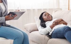 young african woman lying on sofa
